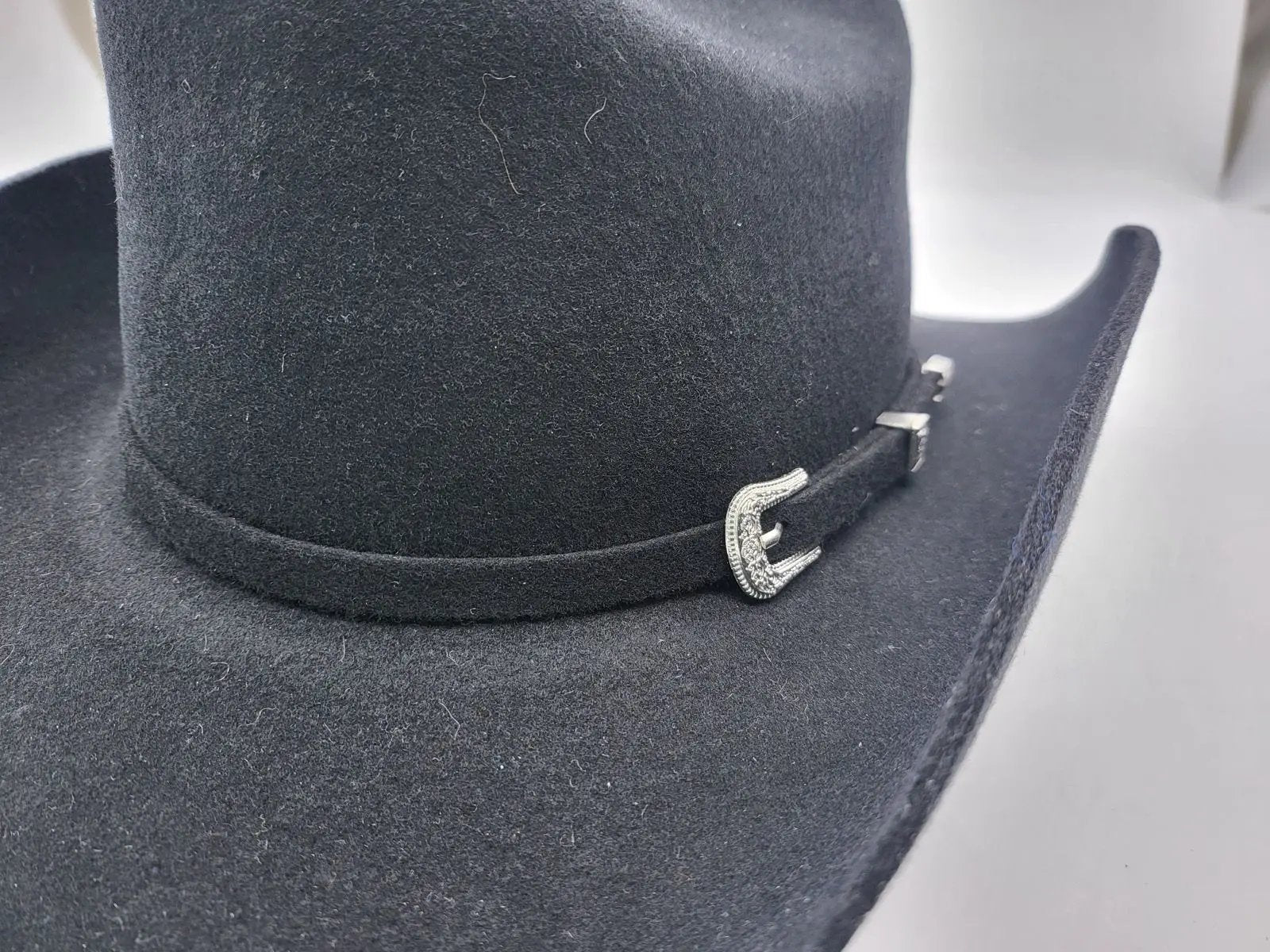 Authentic handmade wool felt cowboy hat crafted for the true Western enthusiast. Built with 100% pure wool for superior shape retention and durability. Available in Black and Brown, sizes 55-60cm. Each hat combines traditional rancher style with premium comfort for lasting quality.