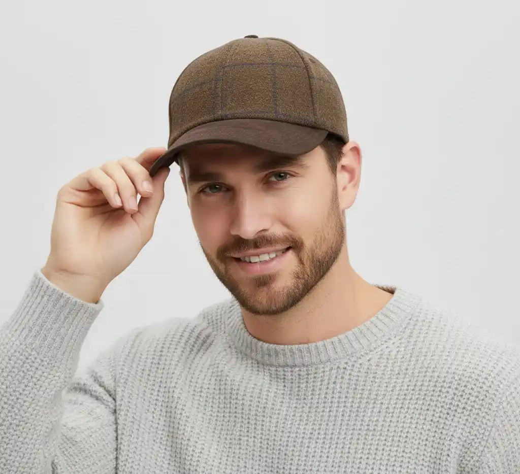 Front view of checked tweed baseball cap with brown suede peak by Novella Hats