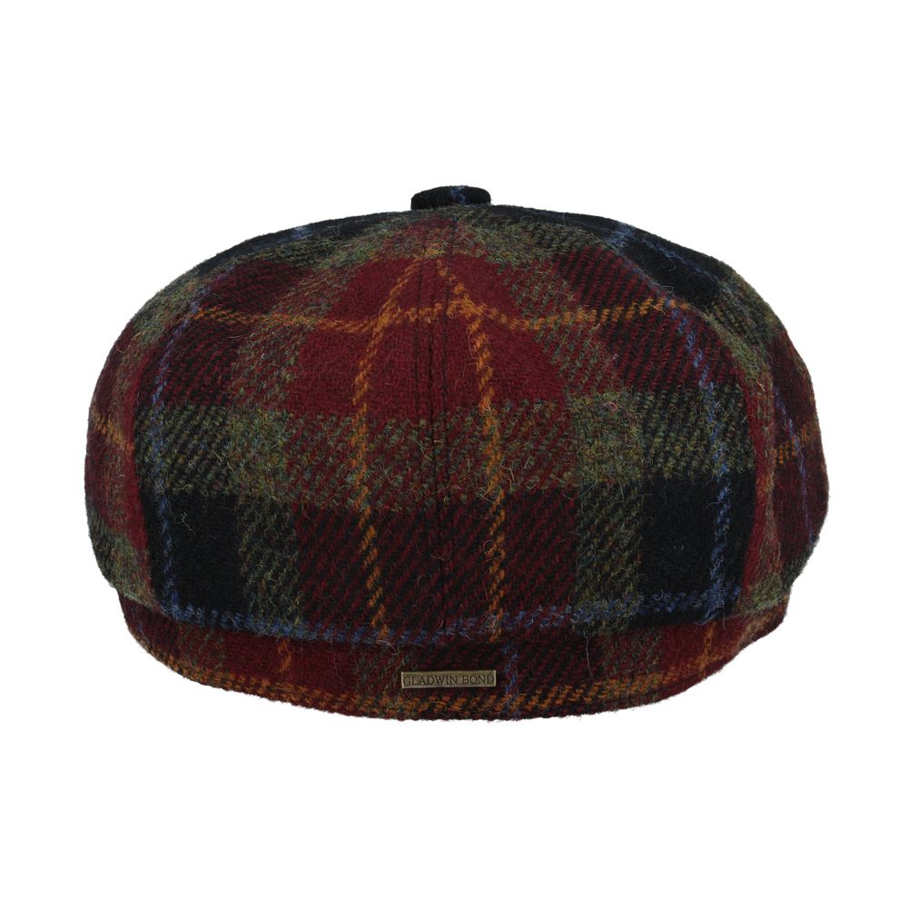 Burgundy Harris Tweed Newsboy Cap, crafted from 100% pure new wool, handwoven in Scotland’s Outer Hebrides. Features include a sewn-down brim, cotton lining, and a removable Gladwin Bond side pin. Available in sizes S-XXL. Inspired by the iconic Peaky Blinders style.