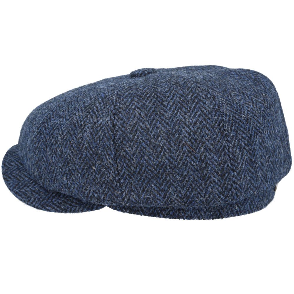 Navy Harris Tweed Herringbone Newsboy Cap, crafted from 100% pure new wool, handwoven in Scotland’s Outer Hebrides. Features include a sewn-down brim, cotton lining, and a removable Gladwin Bond side pin. Available in sizes S-XL. Inspired by the iconic Peaky Blinders style.