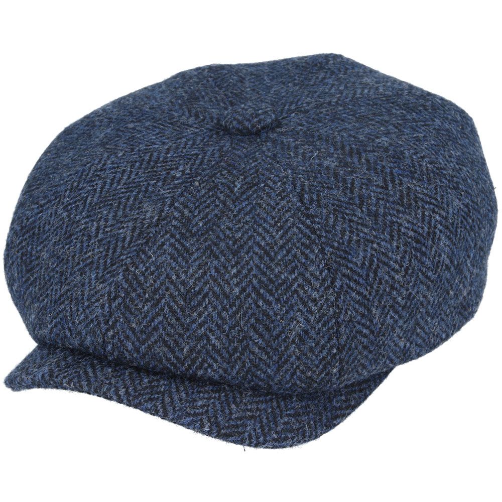 Navy Harris Tweed Herringbone Newsboy Cap, crafted from 100% pure new wool, handwoven in Scotland’s Outer Hebrides. Features include a sewn-down brim, cotton lining, and a removable Gladwin Bond side pin. Available in sizes S-XL. Inspired by the iconic Peaky Blinders style.